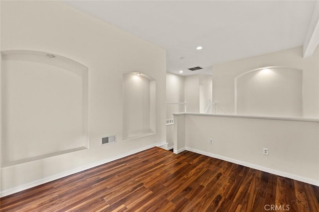 unfurnished room with dark hardwood / wood-style flooring