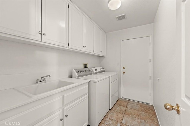 clothes washing area with cabinets, sink, and washing machine and dryer