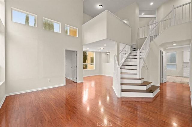 interior space featuring hardwood / wood-style flooring and a towering ceiling