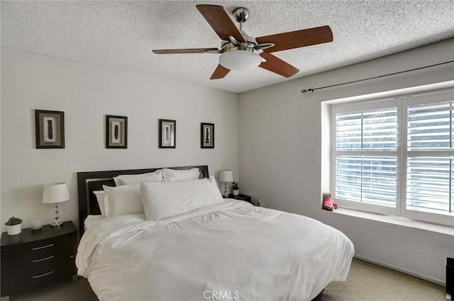 bedroom featuring ceiling fan and a textured ceiling