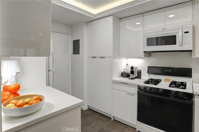 kitchen with dark tile patterned floors, white cabinets, white appliances, and electric panel