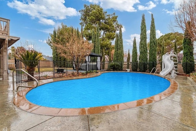 view of pool featuring a gazebo, a water slide, and a patio