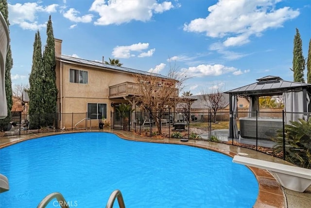 view of pool featuring a gazebo and a diving board