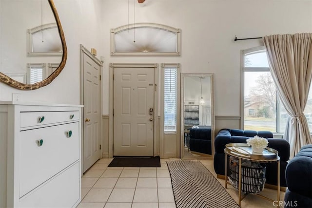 tiled entrance foyer with a towering ceiling