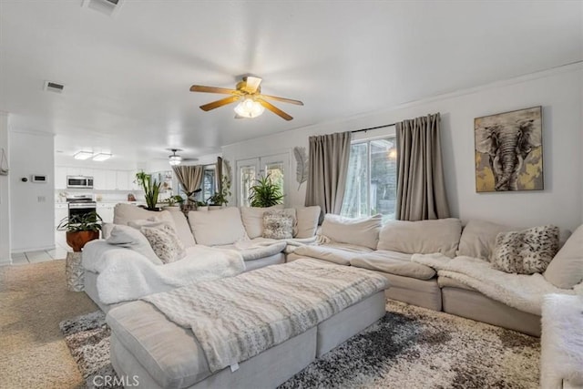 living room with light tile patterned flooring and ceiling fan