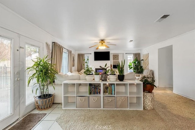 living room featuring light tile patterned flooring, plenty of natural light, and ceiling fan