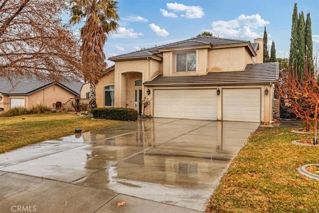 front of property with a garage and a front lawn