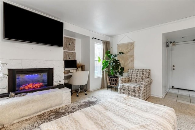 carpeted bedroom with a stone fireplace