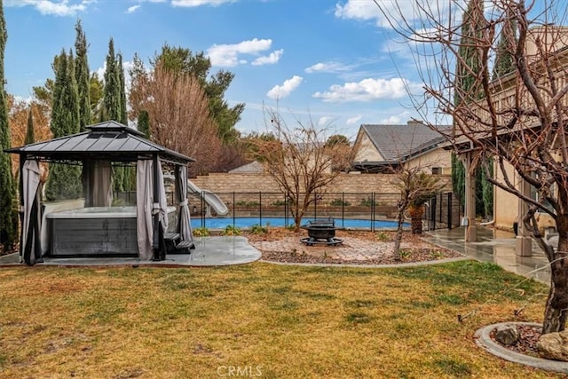 view of yard with a pool, a gazebo, and a fire pit