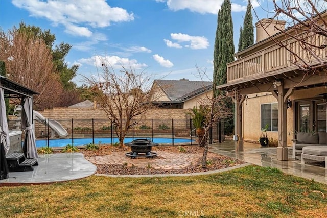 view of yard with an outdoor fire pit and a patio area