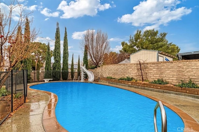 view of swimming pool with a water slide