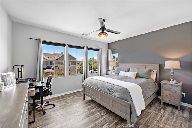 bedroom with ceiling fan and dark hardwood / wood-style floors