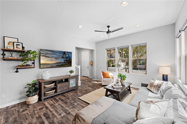 living room with dark wood-type flooring and ceiling fan