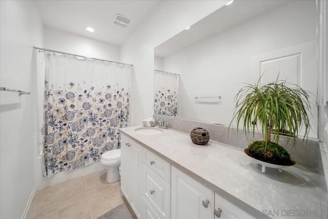 full bathroom featuring tile patterned flooring, vanity, shower / bath combo, and toilet