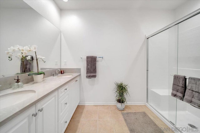 bathroom featuring vanity and a shower with door