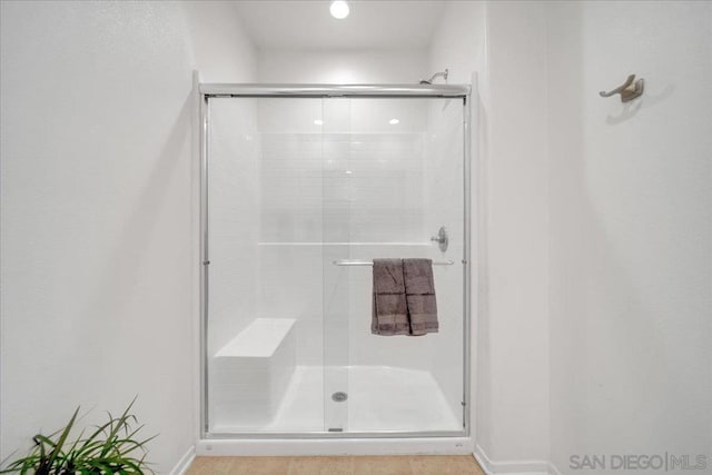 bathroom featuring a shower with shower door