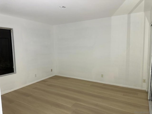 empty room with wood-type flooring