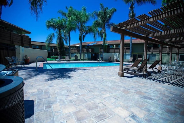 view of swimming pool featuring a pergola and a patio