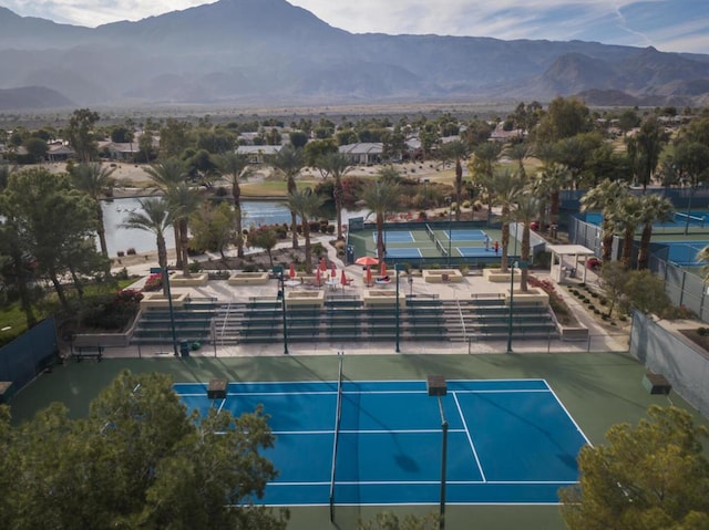 view of tennis court featuring a mountain view