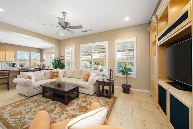 tiled living room featuring ceiling fan