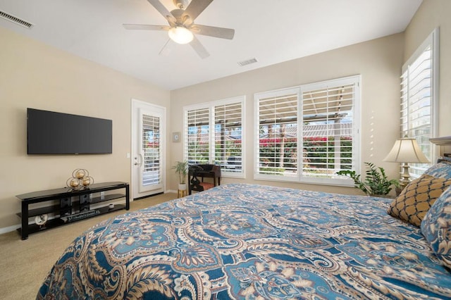 bedroom with multiple windows, carpet floors, access to exterior, and ceiling fan