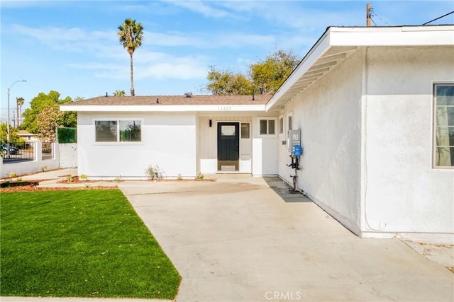 doorway to property featuring a yard and a patio