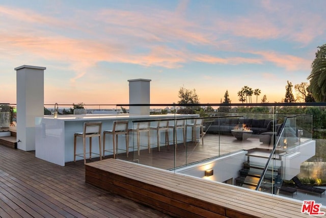 deck at dusk with an outdoor bar