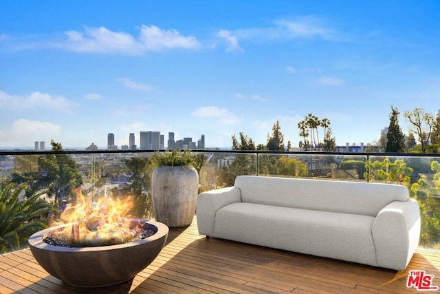 wooden deck featuring an outdoor fire pit