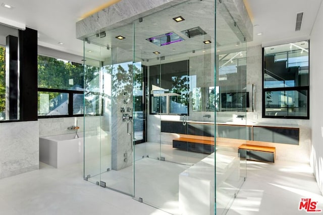 bathroom with a shower with door and vanity