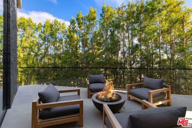 view of patio / terrace featuring an outdoor living space with a fire pit