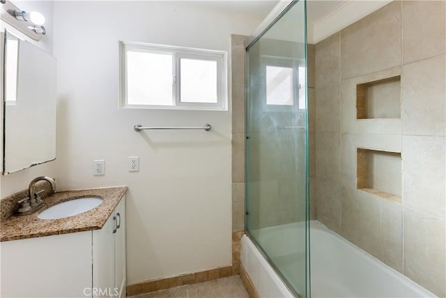 bathroom featuring vanity and bath / shower combo with glass door