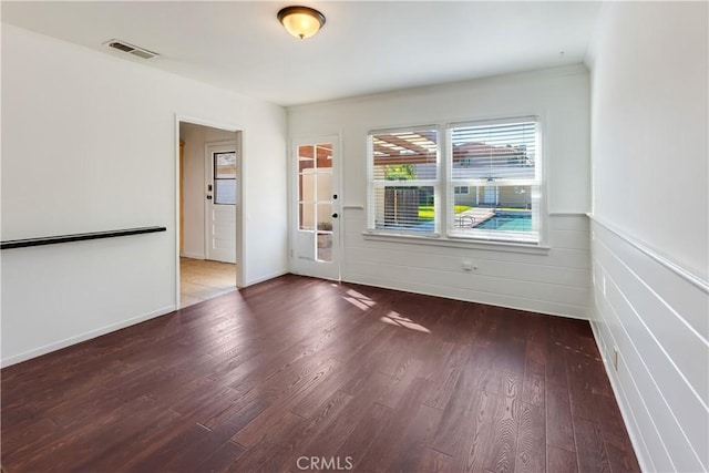 spare room featuring wood-type flooring