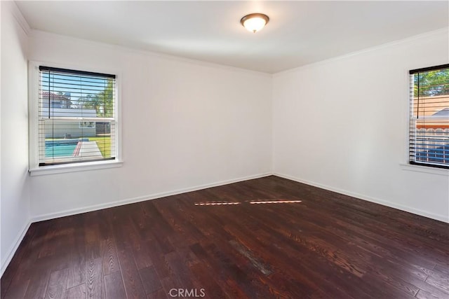 empty room featuring wood-type flooring and ornamental molding