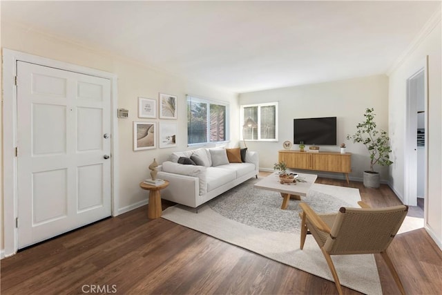 living room featuring dark hardwood / wood-style flooring and crown molding