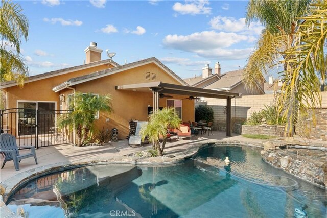 view of pool featuring a patio and an in ground hot tub