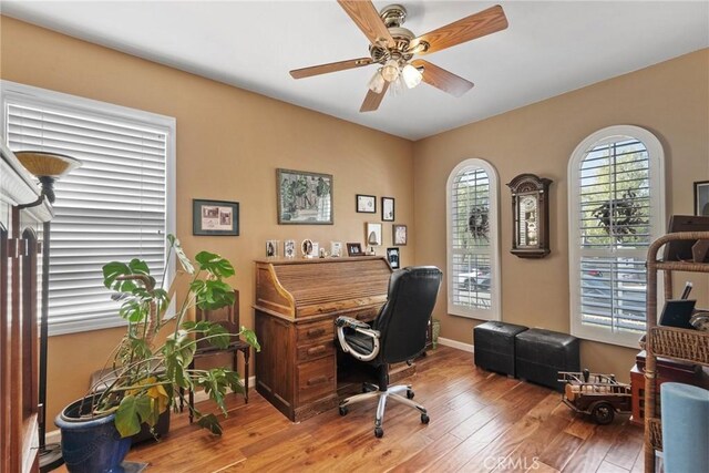 office with hardwood / wood-style floors and ceiling fan