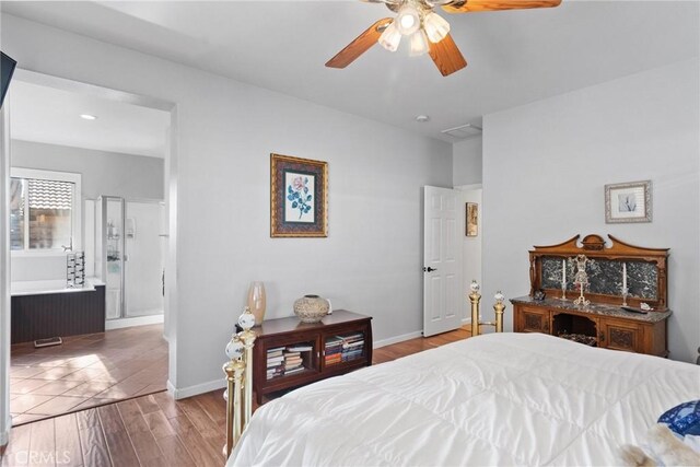 bedroom with ensuite bath, light hardwood / wood-style floors, and ceiling fan