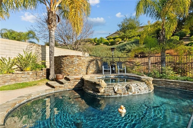 view of swimming pool with an in ground hot tub and pool water feature