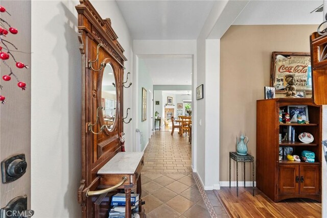 hall featuring light tile patterned floors