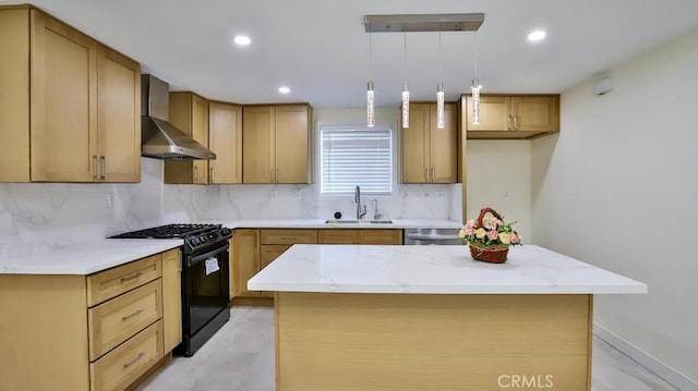 kitchen with black gas range, hanging light fixtures, a center island, and wall chimney exhaust hood