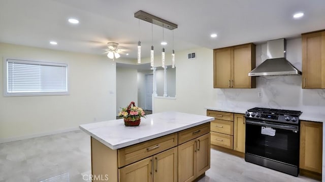 kitchen featuring wall chimney exhaust hood, stainless steel gas stove, tasteful backsplash, decorative light fixtures, and a center island