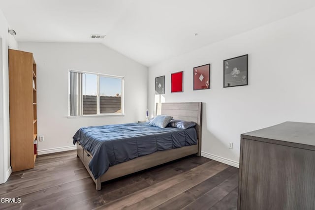 bedroom with vaulted ceiling and dark wood-type flooring