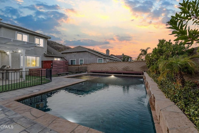 pool at dusk with pool water feature