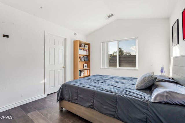 bedroom featuring lofted ceiling and dark wood-type flooring