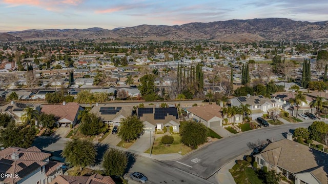 aerial view at dusk featuring a mountain view