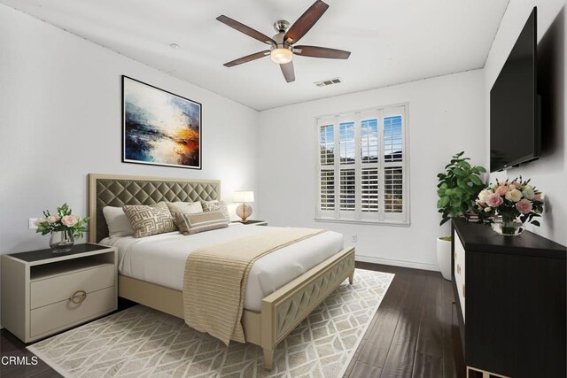 bedroom with ceiling fan and dark hardwood / wood-style flooring