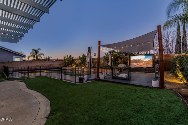 yard at dusk featuring a pergola, a fenced in pool, and a patio area