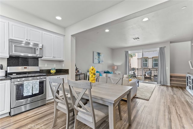 kitchen featuring white cabinetry, appliances with stainless steel finishes, and light hardwood / wood-style floors