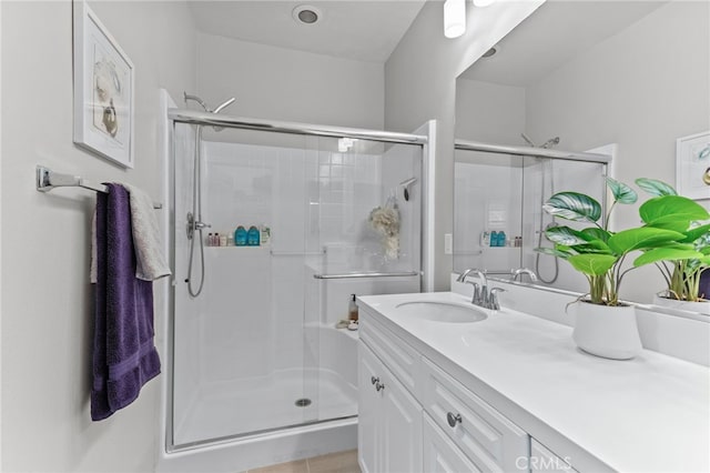 bathroom with vanity and a shower with shower door