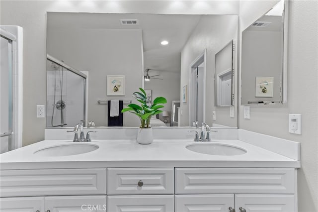 bathroom featuring vanity, an enclosed shower, and ceiling fan